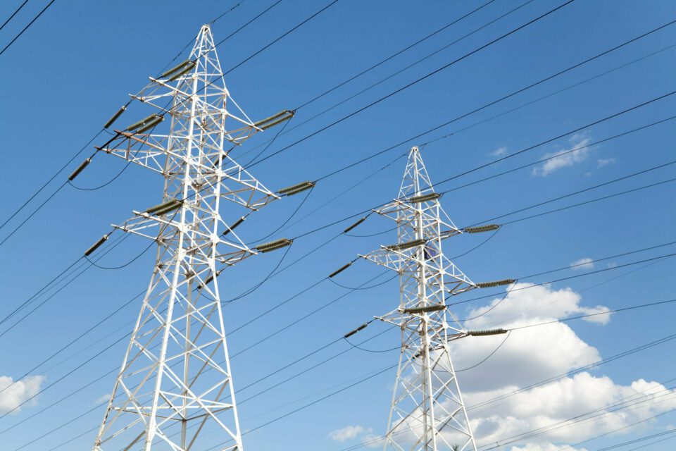Power transmission lines against blue sky